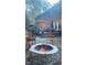 Backyard patio features a stone fire pit with chairs around it, along with a wooden deck at 1004 Staffield Lane Ln, Chapel Hill, NC 27516