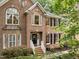 Charming brick home featuring a welcoming front entrance and manicured landscaping at 1004 Staffield Lane Ln, Chapel Hill, NC 27516