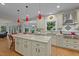 Bright kitchen features custom cabinets, granite countertops, a center island, and stainless appliances at 1004 Staffield Lane Ln, Chapel Hill, NC 27516