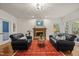 Inviting living room with brick fireplace, hardwood floors, and comfortable seating arrangement at 1004 Staffield Lane Ln, Chapel Hill, NC 27516