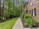 Landscaped side yard with lush greenery and a pathway leading to the house at 1004 Staffield Lane Ln, Chapel Hill, NC 27516