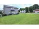 Green backyard with patio, ideal for outdoor gatherings and enjoying nature at 101 Claystone Dr, Gibsonville, NC 27249