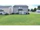 Large, lush backyard with a freshly cut lawn and patio at 101 Claystone Dr, Gibsonville, NC 27249