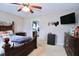 Comfortable bedroom with neutral carpet, a ceiling fan, and a mounted flat screen television at 101 Claystone Dr, Gibsonville, NC 27249