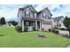 Charming two-story house with a well-kept lawn, mature shrubs, and a two-car garage at 101 Claystone Dr, Gibsonville, NC 27249