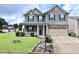 Beautiful two-story home with a well-maintained lawn and tasteful landscaping at 101 Claystone Dr, Gibsonville, NC 27249