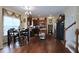 Open concept dining and kitchen area boasts hardwood floors, stainless steel appliances, and ample cabinet space at 101 Claystone Dr, Gibsonville, NC 27249