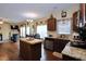 Open concept dining and kitchen area adjacent to a living room with a fireplace at 101 Claystone Dr, Gibsonville, NC 27249