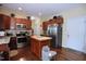 Well-equipped kitchen features stainless steel appliances, granite countertops, and an island for food preparation at 101 Claystone Dr, Gibsonville, NC 27249