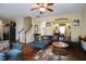 Bright living room featuring a large sectional, hardwood floors, and open layout at 101 Claystone Dr, Gibsonville, NC 27249