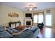Comfortable living area features a fireplace, a ceiling fan, and plush seating at 101 Claystone Dr, Gibsonville, NC 27249