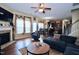 Inviting living room featuring hardwood floors, large windows, a fireplace, and an open floor plan at 101 Claystone Dr, Gibsonville, NC 27249