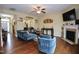 Spacious living room boasts hardwood floors, a ceiling fan, and a cozy fireplace at 101 Claystone Dr, Gibsonville, NC 27249