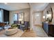Inviting living room with wood floors, stylish decor, and ample natural light entering through the front door at 1033 Masters Place Way # 110, Durham, NC 27703