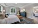 Comfortable main bedroom with abundant natural light and view to the open concept of the home at 1033 Masters Place Way # 110, Durham, NC 27703