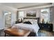Relaxing main bedroom featuring a tray ceiling, soft lighting, and an attached ensuite bathroom at 1033 Masters Place Way # 110, Durham, NC 27703