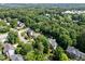 Overhead view of a neighborhood showcasing homes with lush landscaping and mature trees at 105 Spring Bud Dr, Cary, NC 27513