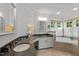 Luxurious bathroom with double vanities, soaking tub, and natural light at 105 Spring Bud Dr, Cary, NC 27513