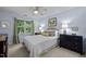 Cozy bedroom with a queen bed, large window, and decorative curtains at 105 Spring Bud Dr, Cary, NC 27513