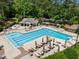 Aerial view of a sparkling community pool with ample lounge chairs and well-maintained landscaping at 105 Spring Bud Dr, Cary, NC 27513