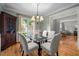 Dining room with glass table, chandelier, and large windows for natural light at 105 Spring Bud Dr, Cary, NC 27513