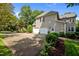 Rear exterior featuring an attached garage, second story, and mature landscaping at 105 Spring Bud Dr, Cary, NC 27513
