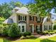 Classic two-story home featuring brick and siding, complete with manicured landscaping and mature trees at 105 Spring Bud Dr, Cary, NC 27513