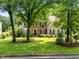 Beautiful two-story home with brick and siding, surrounded by mature trees and a well-maintained lawn at 105 Spring Bud Dr, Cary, NC 27513