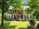 Lovely two-story home with brick and siding, complemented by lush greenery and manicured lawn at 105 Spring Bud Dr, Cary, NC 27513