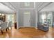 Bright foyer with hardwood floors, large windows, and a glimpse of the dining and living areas at 105 Spring Bud Dr, Cary, NC 27513