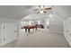 Spacious game room with a pool table, neutral carpeting, and multiple windows at 105 Spring Bud Dr, Cary, NC 27513