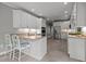 Bright, white kitchen with stainless steel appliances and a peninsula with seating at 105 Spring Bud Dr, Cary, NC 27513