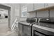 Functional laundry room with stainless steel washer/dryer and utility sink at 105 Spring Bud Dr, Cary, NC 27513