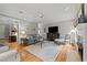 Open-concept living room with fireplace, hardwood flooring, and comfortable seating arrangement at 105 Spring Bud Dr, Cary, NC 27513