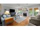 Living room featuring a fireplace, plush seating, and natural light from large windows at 105 Spring Bud Dr, Cary, NC 27513