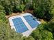 Aerial view of two community tennis courts surrounded by mature trees at 105 Spring Bud Dr, Cary, NC 27513