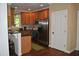Bright kitchen with wood cabinets, stainless steel appliances, and an island counter with seating at 110 Ruth St, Carrboro, NC 27510