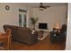 Bright living area with hardwood floors, cozy seating, and natural light from a french door at 110 Ruth St, Carrboro, NC 27510