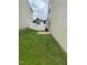 A backyard with a privacy fence and a grassy area, surrounded by the siding of neighboring homes at 11017 Peacock Moss St, Raleigh, NC 27613