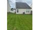 A backyard featuring a grass yard and a white fence that provides a defined property boundary at 11017 Peacock Moss St, Raleigh, NC 27613