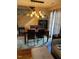 This is a dining room with modern chandelier, and staircase, next to a door with curtains at 11017 Peacock Moss St, Raleigh, NC 27613
