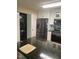 Modern kitchen with stainless steel appliances, white cabinets, and convenient laundry area at 11017 Peacock Moss St, Raleigh, NC 27613