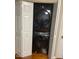 Efficient laundry closet with stackable washer and dryer hidden behind folding doors at 11017 Peacock Moss St, Raleigh, NC 27613