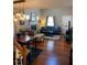 Cozy living room with hardwood floors, fireplace and comfortable seating, next to the dining area at 11017 Peacock Moss St, Raleigh, NC 27613