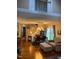 Bright living room area featuring hardwood floors, dining area, and natural light from sliding glass door at 11017 Peacock Moss St, Raleigh, NC 27613