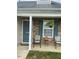 Inviting front porch with stone accents, seating, and a well-maintained yard at 11017 Peacock Moss St, Raleigh, NC 27613