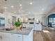 Bright open kitchen with a large island, stainless steel appliances, and hardwood floors at 1107 Masters Place Way # 155, Durham, NC 27703