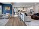 Open-concept living room with a large sofa, hardwood floors, and a view into the kitchen at 1107 Masters Place Way # 155, Durham, NC 27703