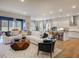 Spacious living room with a white sofa, modern furniture, and an open kitchen at 1107 Masters Place Way # 155, Durham, NC 27703