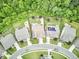An aerial view of several homes situated in a lush green, wooded area at 112 Filigree Way, Durham, NC 27713